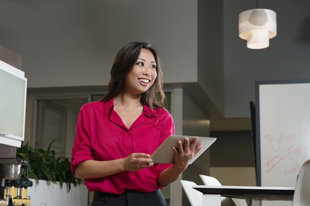 Lady in bright pink shirt in meeting room 