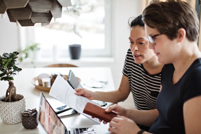 Two ladies looking at invoice 