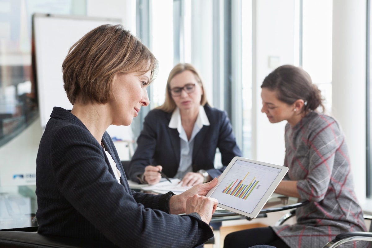 woman looking at graph on tablet