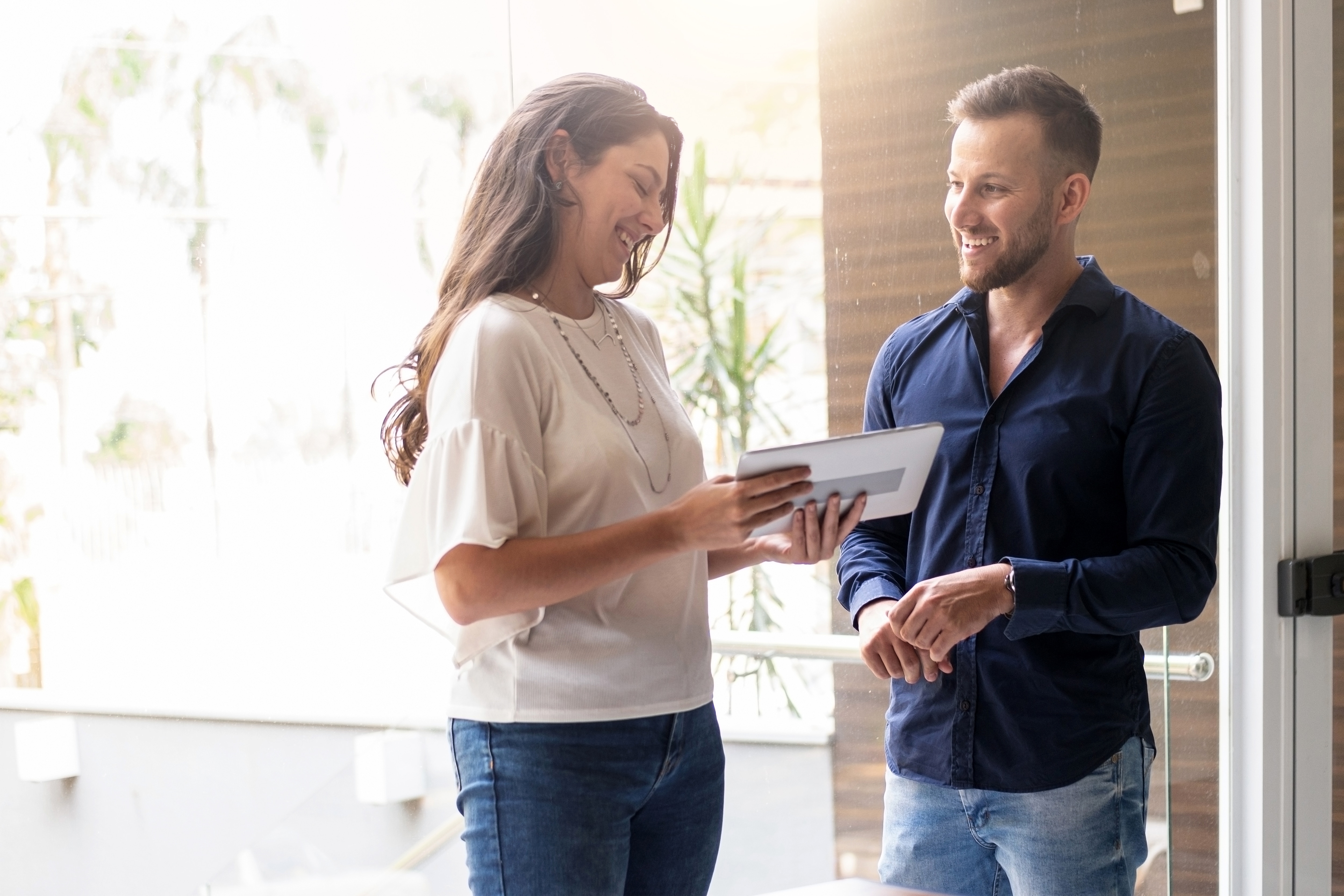 Two people looking at a tablet