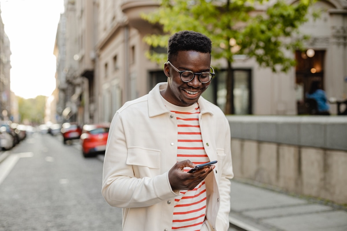 man smiling at phone