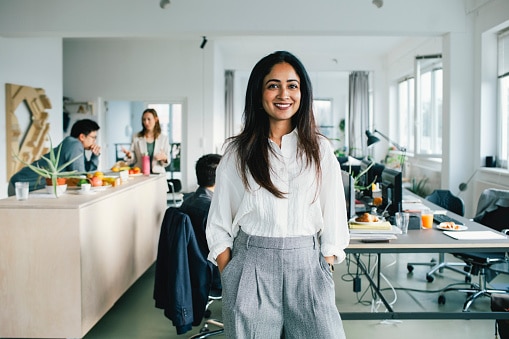 Lady in white shirt standing in office 