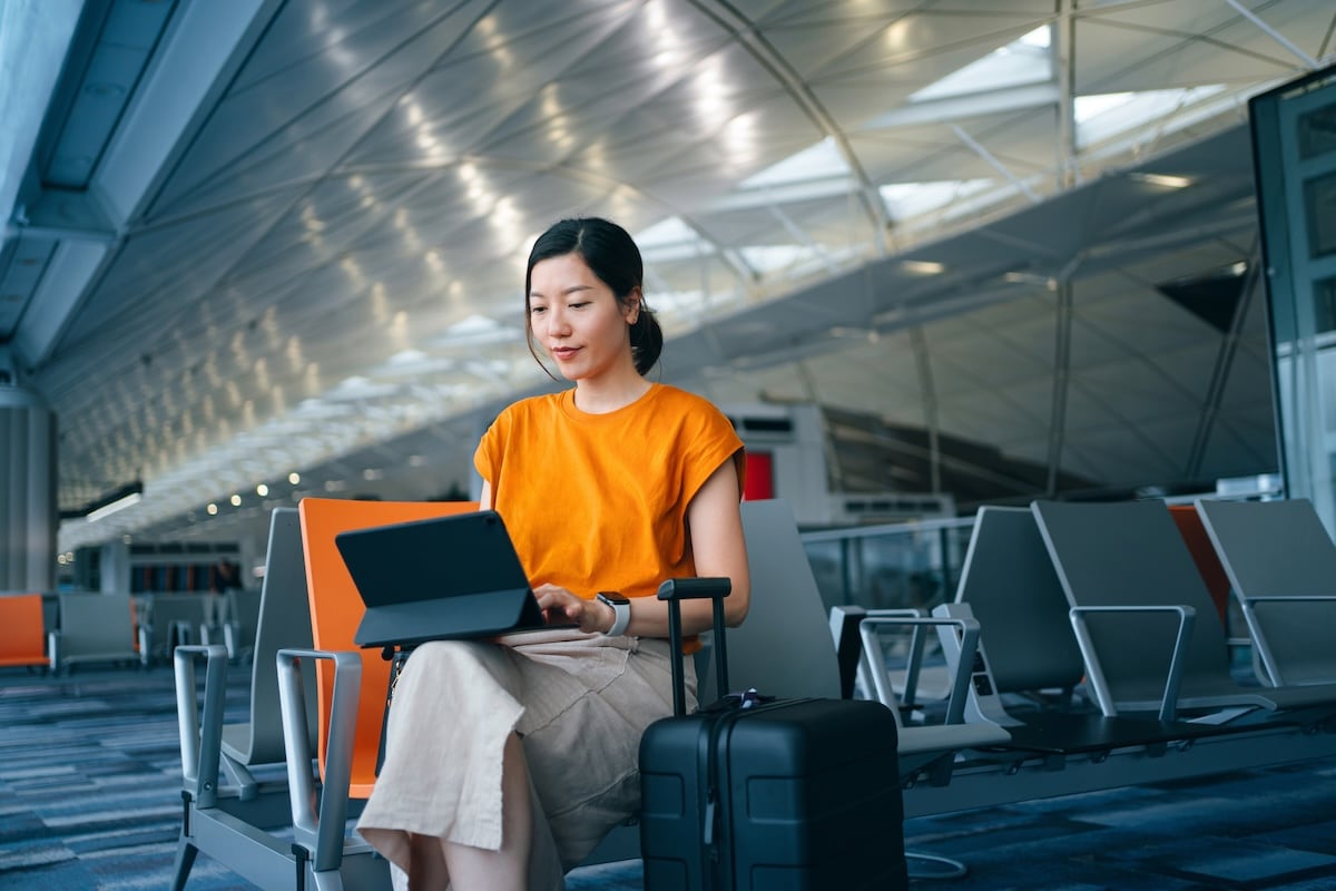 woman on laptop at airport